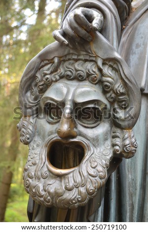 ST.PETERSBURG, RUSSIA - MAY 13, 2012: Statue of a theatrical mask in Pavlovsk park, suburb of St. Petersburg.