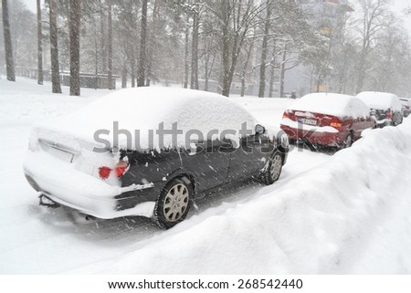KOTKA, FINLAND - DECEMBER 4, 2012: Cars covered with snow on parking in heavy snow.