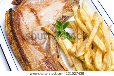 Roasted pork steak and fried chips