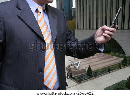 Businessman in a business-park making a call