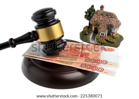 Hammer of judge with money and model of house isolated on white background
