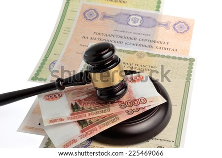 Hammer of judge with money, maternal and birth certificates isolated on white