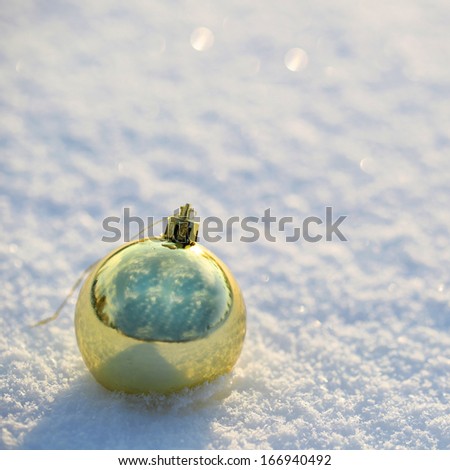 Gold Christmas Balls on Snow. Outside. Winter Sunny Day.