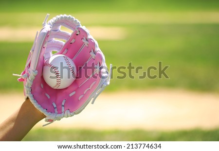 Hand of Baseball Player with Pink Glove and Ball over Field