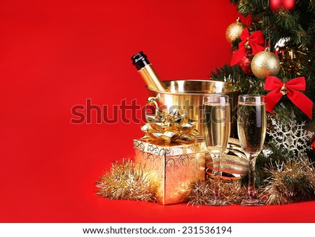 Christmas or New Year\'s Eve. Champagne and Presents over Red Background. Celebration