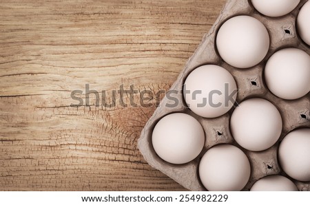 White eggs on wooden background