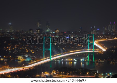 Istanbul. The night view of Bosphorus Bridge. Turkey Istanbul glowing hanging bridge over the Bosphorus on the background panorama of the city at night.