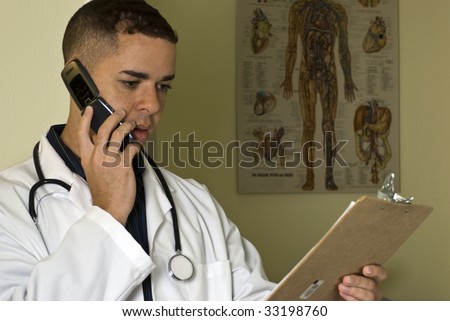 A doctor using his cell phone to discuss the lab results he is reviewing.