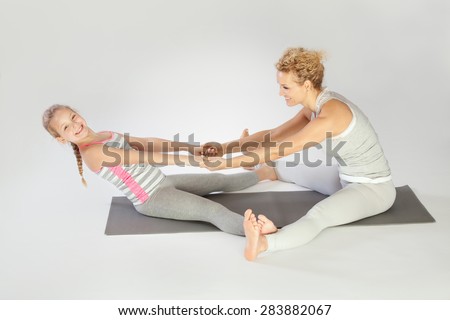 Yoga / Mother and daughter doing yoga exercise