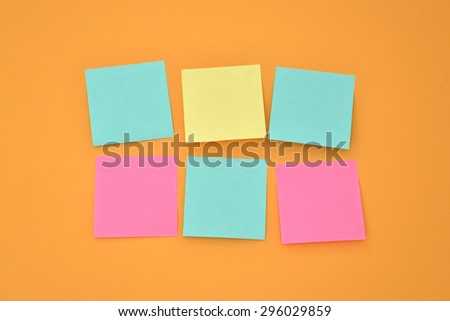 Six sticky note on a bright orange wall