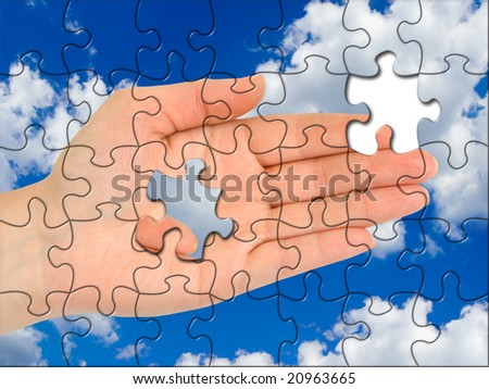 Puzzle hand without one piece, sky on background
