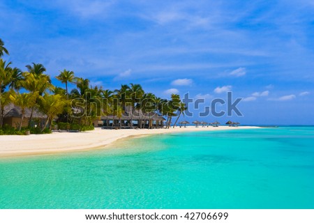 Beach bungalows on a tropical island - vacation background