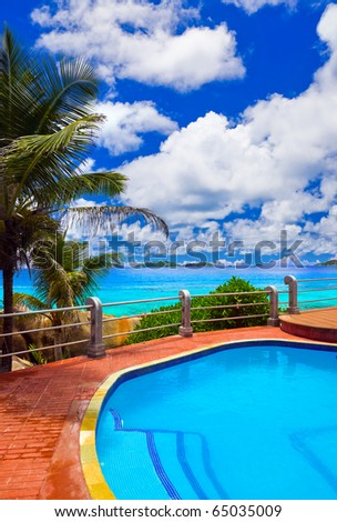 Pool in hotel at tropical beach - vacation background
