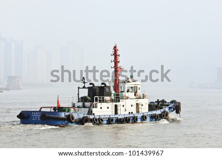 SHANGHAI-NOV. 20, 2010. Tug boat on Nov. 20, 2010 in Shanghai. Shanghai port overtook in 2010 Singapore port to become the world\'s busiest container port. Shanghai\'s port handled 29.05 million TEU.