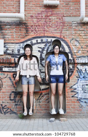 BEIJING JUNE 1, 2012. Girls in an artwork on June 1, 2012 in Beijing Art District. Zhang Zhouhui created \'You and me\' as an interactive artwork and encourage people send photos for a digital artwork.