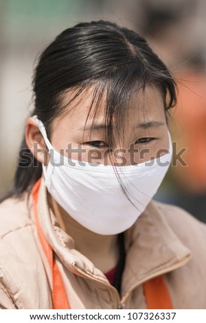 BEIJING MARCH 28, 2007. Woman with mouth cap on March 28, 2007. Beijing air quality is 16 times worse than New York City. U.S. Embassy staff frequently recorded Beijing air as beyond hazardous