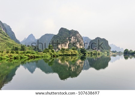 Oddly shaped Karst mountains reflected in water in Yangshuo, Guangxi Province, China