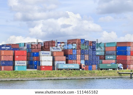 ROTTERDAM-AUG. 7: Piled up containers on Aug. 7, 2012 in Port of Rotterdam, The Netherlands.  It is the largest port in Europe covering 105 square kilometers and stretches over a distance of 40 KM.