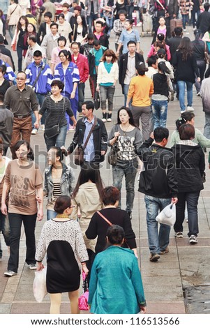 DALIAN-CHINA-OCT. 14, 2012. Crowd on Oct 14, 2012 in Dalian. China\'s estimated population is 1,338,612,968. 21% of population (145,461,833 males; 128,445,739 females) are 14 years old or younger.