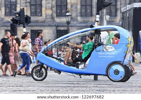 AMSTERDAM-AUG. 19. Rickshaw at Dam square. 38% of traffic movement in A\'dam is by bike, 37% by car, 25% by public transport. In the center, 57% of traffic movement is by bike. Amsterdam, Aug. 19, 2012