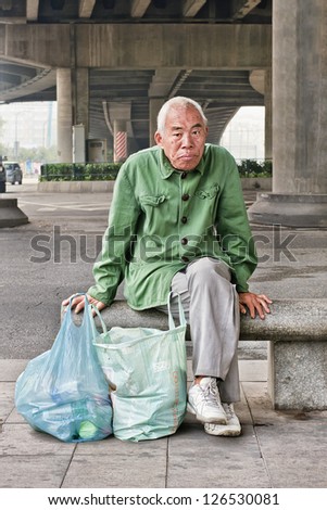 GUANGZHOU-JAN. 9: Recyclable trash collector. More than a million migrant workers scour streets and rummage through trash bins for salable recyclables in Chinese cities. Guangzhou, Jan. 9, 2008.