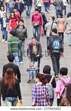 DALIAN-CHINA-OCT. 14, 2012. Crowd on Oct 14, 2012 in Dalian. With a population of over 1.3 billion and dwindling natural resources, China is concerned and has a ??one-child policy??, family planning.