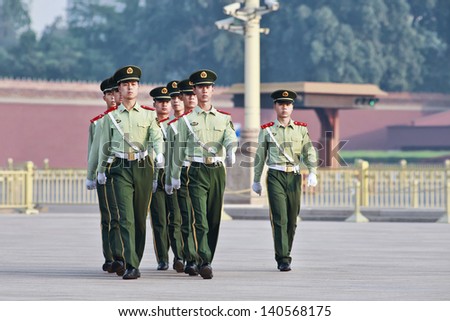 BEIJING-JUNE 1. Honor guards marching at Tiananmen. Honor guards are provided by People\'s Liberation Army at Tiananmen Square for flag-raising ceremony and Tiananmen presence. Beijing, June 1, 2013.