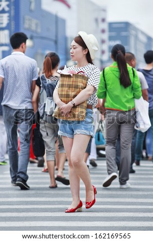 CHANGCHUN-CHINA-JULY 8. Fashionable girl in city center. Because of the ongoing prosperity and westernization, fashion is on the minds of China\'s young urban generation. Changchun, July 8, 2013.