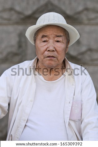 CHANGCHUN-JUNE 14. Chinese old man dressed in white. China\'??s elderly population (60 or older) is about 128 million, with one in every ten people the largest in the world. Changchun, June 14, 2007.