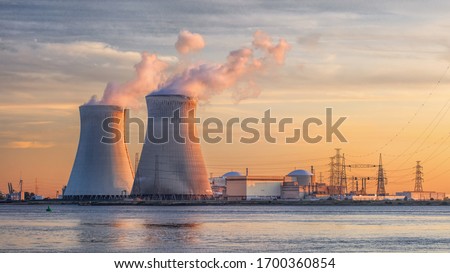 Late afternoon scene with view on riverbank with nuclear reactor Doel, Port of Antwerp, Belgium.