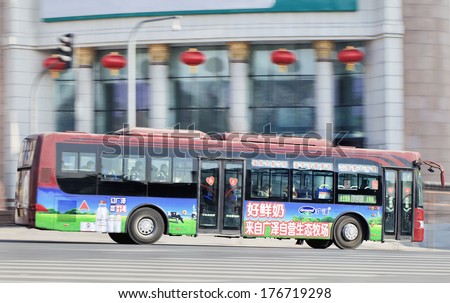CHANGCHUN, CHINA - JAN. 31, 2014. Bus on the road. Cheapest way to travel around Changchun is by city bus which is centered around many bus routes, it cost 1 RMB to take bus no matter where ever you get off.