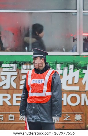 HEFEI-CHINA-JAN. 6, 2009. Distressed policeman on an early rainy morning. Unlike US or Hong Kong police, most policemen in China don not carry guns except when they are on a special assignment.