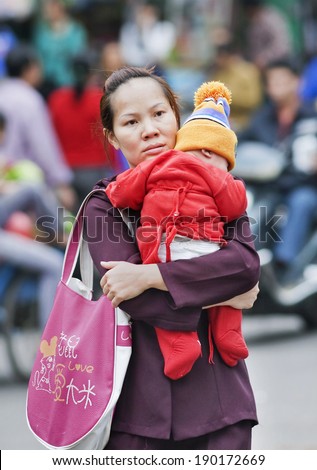 SANYA-JAN. 16, 2008. Chinese mother with her child. Chinese government plans to relax the its one child policy: couples in which either member is an only child will be permitted to have two children.