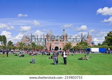 AMSTERDAM-AUG. 24, 2014. People enjoy a summer day on Museum Square. Several museums are located around the very touristy square: Rijksmuseum, Van Gogh Museum, Stedelijk Museum and Diamond Museum.