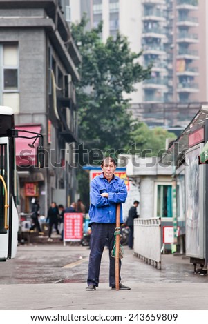 CHONGQING-NOVEMBER 4, 2014. Male Chinese worker Lost in thought. The Chinese workers wage rate is about 5 percent of the US, 6 percent of the South Korean, and 40 percent of the Mexican level.