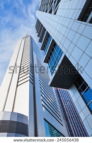 Sharp lines from modern architecture against a blue sky.