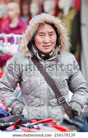 HENGDIAN-DEC. 29, 2014. Female vendor on a market. When they settle in cities, many migrants become vendors. It requires small investment, but because of its informality, it is often sanctioned.