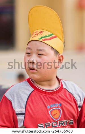 BEIJING-MAY 21, 2008. Over weighted boy with funny hat. China\'s child obesity is alarming: According a recent study, 23% of Chinese boys under age 20 are overweight, comparable figure for girls is 14%