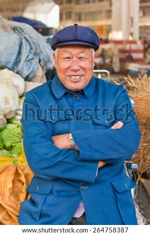 WEIHAI-DEC. 1, 2006. Traditionally dressed Farmer on a market. According Academy of Social Science 40 to 50 million farmers are landless. Rural pension is 12,000 yuan, urban pension 33,000 yuan a year