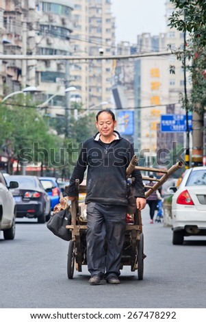 WENZHOU-NOV. 19, 2014. Trash collector on the street. In China recycling is done by trash collectors who specialize in different kinds of refuse, either collect these materials by sort through garbage
