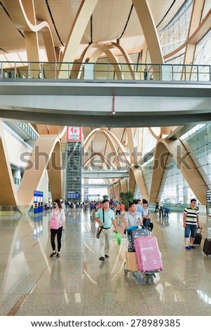 KUNMING-JULY 14, 2014. Spacious interior of Kunming Changshui International Airport with travelers walking around. It is the primary airport serving Kunming, the capital of Yunnan Province, China.