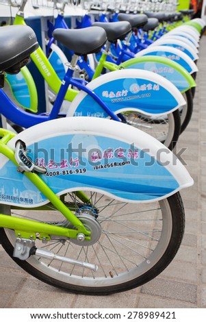 BEIJING-MAY 5, 2015. Bicycles parked in public bicycle sharing station. Bicycle sharing allow to hire on a very short term basis, it\'s a popular transport mode among commuters in major Chinese cities.