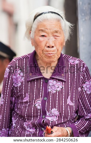 BEIJING-JUNE 1, 2015. White haired old women. Elderly population (60 or older) in China is about 128 million, one in every ten people, the world\'s largest. China will have 400 million elderly by 2050.