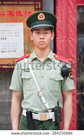 BEIJING-JUNE 1, 2015. Honor guard in front of a building. Honor guards are provided by the People\'s Liberation Army at Tiananmen Square for flag-raising ceremony and presence around Tiananmen.