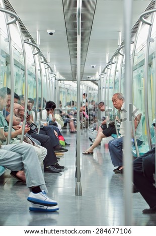 BEIJING-JUNE 2, 2015. Inside a subway car. Rapid transit rail network that serves Beijing urban and suburban districts, 18 lines, 319 stations, 527 KM track, averaging 9.2786 million trips per day.