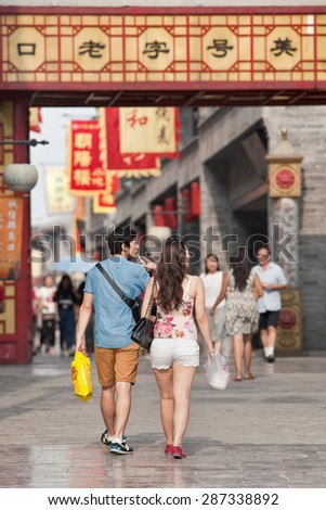 BEIJING-JUNE 9, 2015. Young lovers in city center. According 2010 national census, China\'s unmarried population is huge: 249 million 18-and-older Chinese are not married (18.6% of total population).