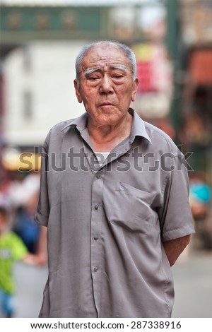 BEIJING-JUNE 9, 2015. Old Chinese man. The elderly population (60 or older) in China is about 128 million, one in every ten people, the world\'s largest. China will have 400 million elderly by 2050.