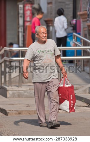 BEIJING-JUNE 9, 2015. Fashionable Old Chinese man. Elderly population (60 or older) in China is 128 million, one in every ten people, the world's largest. China will have 400 million elderly by 2050.