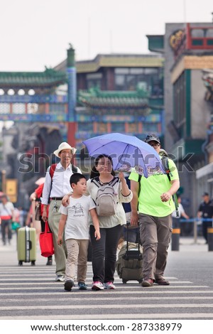 BEIJING-JUNE 9, 2015. Fat Chinese family with umbrella. China\'s getting fatter, it\'s weighing down the future of its children. It has 46 million obese Chinese adults and 300 million who are overweight