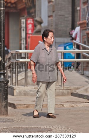 BEIJING-JUNE 9, 2015. Old Chinese lady. The elderly population (60 or older) in China is about 128 million, one in every ten people, the world\'s largest. China will have 400 million elderly by 2050.